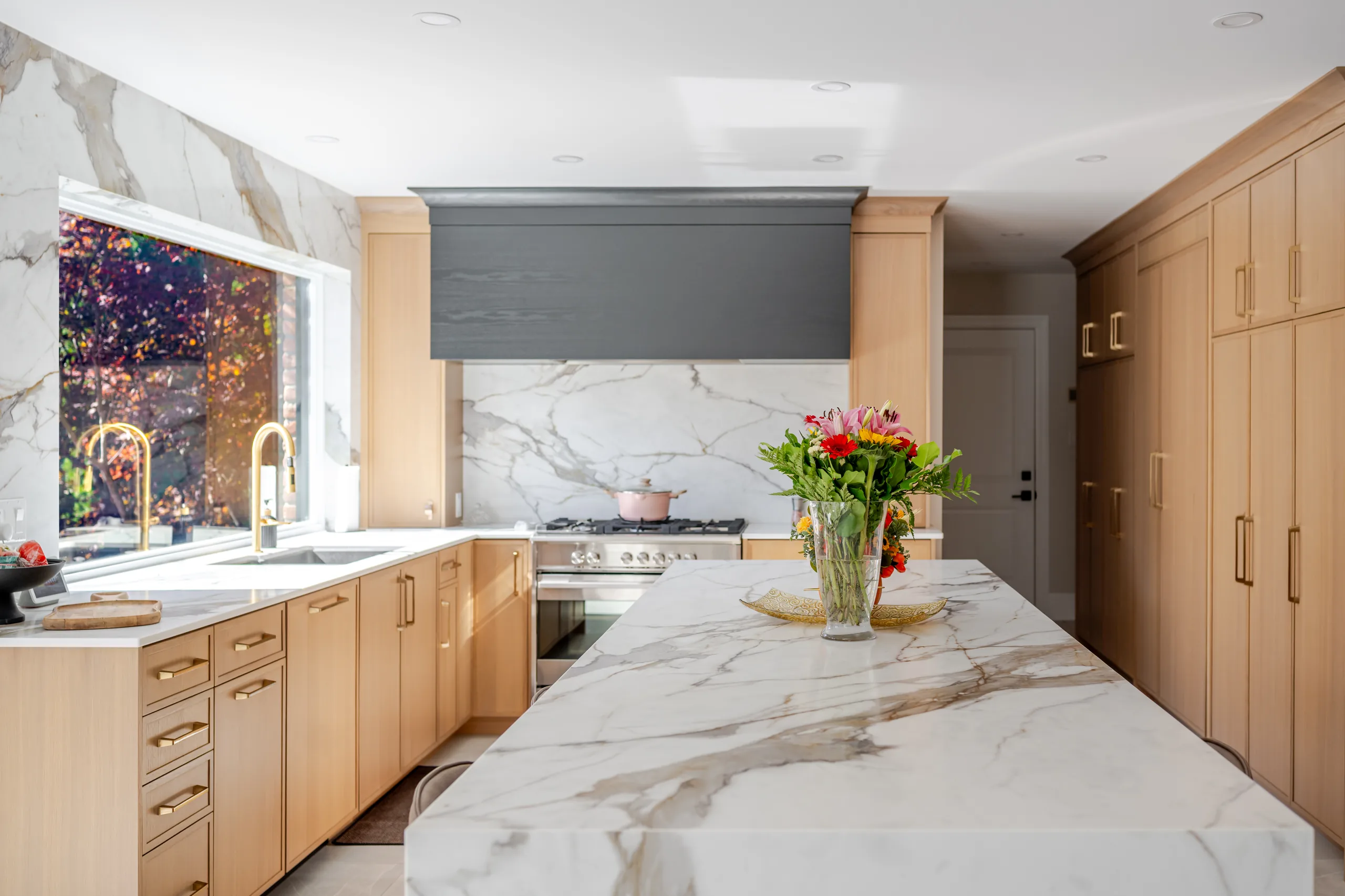 Custom kitchen with waterfall island and wood cabinetry in London Ontario
